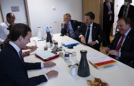 Dutch Prime Minister Mark Rutte ( 2 nd R) speaks with Sweden's Prime Minister Stefan Lofven (R) Austria's Chancellor Sebastian Kurz (L) during a meeting at the European Council building in Brussels, on July 18, 2020, as the leaders of the European Union hold their first face-to-face summit over a post-virus economic rescue plan. - The EU has been plunged into a historic economic crunch by the coronavirus crisis, and EU officials have drawn up plans for a huge stimulus package to lead their countries out of lockdown. (Photo by Francisco Seco / POOL / AFP)