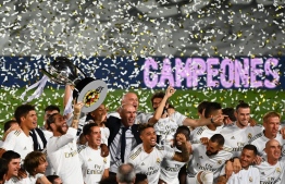 Real Madrid's players celebrate winning the Liga title  after the Spanish League football match between Real Madrid CF and Villarreal CF at the Alfredo di Stefano stadium in Valdebebas, on the outskirts of Madrid, on July 16, 2020. (Photo by GABRIEL BOUYS / AFP)