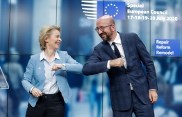 European Commission President Ursula Von Der Leyen (L) and European Council President Charles Michel (R) bump elbows at the end of the news conference following a four days European summit at the European Council in Brussels, Belgium, early July 21, 2020. - EU leaders approved a 750-billion-euro package to revive their coronavirus-ravaged economies after a tough 90-hour summit on July 21, along with a trillion-euro budget for the next seven years. PHOTO: STEPHANIE LECOCQ / POOL / AFP