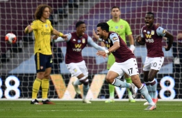 Aston Villa's Egyptian midfielder Trezeguet celebrates scoring the opening goal during the English Premier League football match between Aston Villa and Arsenal at Villa Park in Birmingham, central England on July 21, 2020. (Photo by PETER POWELL / POOL / AFP) / RESTRICTED TO EDITORIAL USE. No use with unauthorized audio, video, data, fixture lists, club/league logos or 'live' services. Online in-match use limited to 120 images. An additional 40 images may be used in extra time. No video emulation. Social media in-match use limited to 120 images. An additional 40 images may be used in extra time. No use in betting publications, games or single club/league/player publications. / 