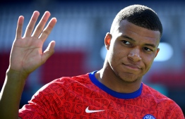 Paris Saint-Germain's French forward Kylian Mbappe waves ahead of the friendly football match between Paris Saint-Germain (PSG) and Glasgow Celtic FC at the Parc des Princes Stadium in Paris on July 21, 2020. (Photo by FRANCK FIFE / AFP)