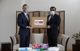 US Deputy Chief of Mission (DCM) to Sri Lanka and Maldives Martian Kelly hands over Personal Protection Equipment (PPE) gifted for the Maldives' COVID-19 response to the Maldivian High Commissioner to Sri Lanka Omar Razak. PHOTO: SRI LANKAN HIGH COMMISSION