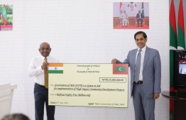 Minister Abdulla Shahid and Indian Ambassador Sunjay Sudir with the symbolic cheque. PHOTO: MINISTRY OF FOREIGN AFFAIRS