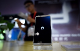 (FILES) This file photo taken on July 9, 2018 shows a Huawei mobile phone on display at the Beijing International Consumer Electronics Expo in Beijing. - Huawei has overtaken Samsung to become the number one smartphone seller worldwide in the second quarter this year, industry tracker Canalys said on July 30, 2020. (Photo by WANG ZHAO / AFP)