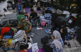 Refugee families camp at Victoria square in central Athens, on July 29, 2020. - Around 100 mostly Afghan refugees have been camping in a square in recent day0000s under temperatures exceeding 30 degrees Celsius (86 Fahrenheit) after arriving from island's camps. Refugees who were awarded asylum over a month ago, are allowed to leave Moria and other camps and sail to Athens, but without further assistance. "The camp authorities told us to leave Moria. But we were not told where to go, where to find assistance," a refugee says. PHOTO: LOUISA GOULIAMAKI / AFP