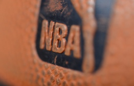 (FILES) In this file photo taken on January 08, 2013 a detail view of the Spalding ball with NBA logo is seen during the game between the Orlando Magic and the Denver Nuggets at the Pepsi Center in Denver, Colorado. PHOTO: GARETT ELLWOOD / NBAE / GETTY IMAGES / AFP