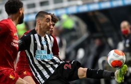 Newcastle United's Paraguayan midfielder Miguel Almiron (C) vies with Liverpool's English defender Joe Gomez (L) during the English Premier League football match between Newcastle United and Liverpool at St James' Park in Newcastle-upon-Tyne, north east England on July 26, 2020. (Photo by OWEN HUMPHREYS / POOL / AFP)
