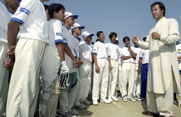 (FILES) This file photo taken on June 20, 2003 shows former Pakistan cricket captain Imran Khan (R) giving tips to his students during a cricket class conducted under the auspices of the Pakistan Cricket Board and Pepsi in Rawalpindi. - To understand the culture of fast bowling in Pakistan, look no further than Imran Khan, whose rise underlines a tradition where speed is king, and blistering pace is essential for any team. As if to reinforce the point, Pakistan have eight quicks in their 20-man squad for the three-Test series against England, starting on August 5, 2020, ready to unleash their trademark pace and swing. PHOTO: JEWEL SAMAD / AFP