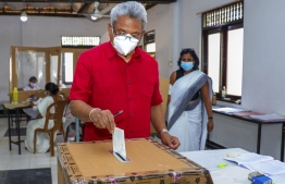 In this handout photograph released by the Department Of Government Information Media Division on August 5, 2020 Sri Lanka's President Gotabaya Rajapaksa casts his ballot at a polling station in Colombo. - Sri Lankan voters cast their ballots on August 5 for a new parliament as the ruling Rajapaksa brothers seek a fresh mandate to cement their grip on power. (Photo by - / Department Of Government Information Media Division / AFP) / 