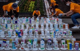 Volunteers lit up lanterns with messages to mark the 75th anniversary of atomic bombing, at Nagasaki Peace Park, in Nagasaki on August 8, 2020. (Photo by Philip FONG / AFP)