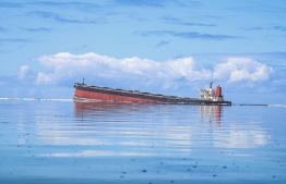 This general view taken on August 7, 2020, shows the vessel MV Wakashio, belonging to a Japanese company but Panamanian-flagged, that ran aground near Blue Bay Marine Park off the coast of south-east Mauritius. - France on August 8, 2020 dispatched aircraft and technical advisers from Reunion to Mauritius after the prime minister appealed for urgent assistance to contain a worsening oil spill polluting the island nation's famed reefs, lagoons and oceans. Rough seas have hampered efforts to stop fuel leaking from the bulk carrier MV Wakashio, which ran aground two weeks ago, and is staining pristine waters in an ecologically protected marine area off the south-east coast. (Photo by Daren Mauree / L'Express Maurice / AFP
