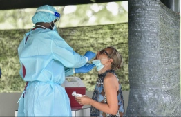 Health care worker collecting a sample from a tourist at the sampling station. PHOTO: NBAM