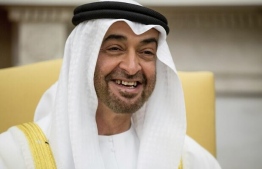 FILE - In this May 15, 2017, file photo, Abu Dhabi’s crown prince, Sheikh Mohammed bin Zayed Al Nahyan, smiles during a meeting with President Donald Trump at the White House in Washington. Emails obtained by The Associated Press between business partners Elliott Broidy and George Nader indicate that the pair was working with bin Zayed in a lobbying effort to alter U.S. policy in the Middle East. (AP Photo/Andrew Harnik, File)