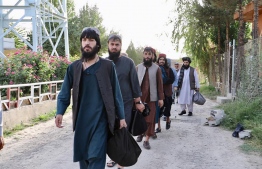 In this handout photograph taken on August 13, 2020 and released by Afghanistan's National Security Council (NSC), Taliban prisoners walk as they are in the process of being released from Pul-e-Charkhi prison on the outskirts of Kabul. -(Photo by - / Afghanistan's National Security Council (NSC) / AFP) /