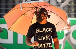Mercedes' British driver Lewis Hamilton sports a "Black Lives Matter" t-shirt on the grid before the race at the Circuit de Catalunya in Montmelo near Barcelona on August 16, 2020, during the Spanish Formula One Grand Prix. (Photo by ALBERT GEA / POOL / AFP)