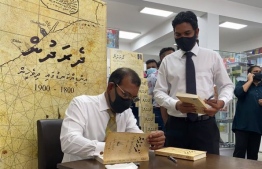 Nasheed signing a copy of his book at Novelty bookshop on Wednesday. PHOTO: TWITTER