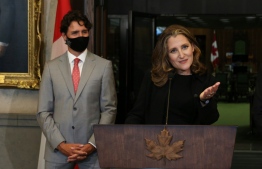 Canada's Deputy Prime Minister/Finance Minister Chrystia Freeland (R) speaks during a news conference on Parliament Hill August 18, 2020 in Ottawa, Canada, as Prime Minister Justin Trudeau looks. - Prime Minister Justin Trudeau tapped Chrystia Freeland to be Canada's first female finance minister on Tuesday as an ethics scandal that clipped her predecessor's wings reverberates through the government. Freeland received a standing ovation after being sworn in at a small ceremony at Rideau Hall, the official residence of Governor General Julie Payette in Ottawa. (Photo by Dave Chan / AFP)