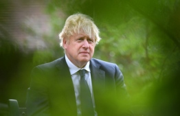 Britain's Prime Minister Boris Johnson attends a national service of remembrance at the National Memorial Arboretum in Alrewas, central England on August 15, 2020, to mark the 75th anniversary of VJ (Victory over Japan) Day. (Photo by Anthony Devlin / POOL / AFP)