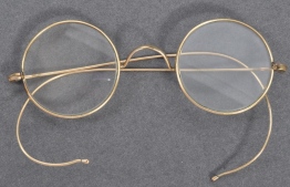 A handout picture released by East Bristol Auctions on August 19, 2020 shows a pair of glasses that once belonged to Indian independence icon Mohandas Karamchand Gandhi photographed at the action house in Bristol head of their sale. A pair of personal spectacles once owned by Mahatma Gandhi is to go on sale on August 21 at East Bristol Auctions with a pre-sale estimate of 10,000 to 15,000 GBP (13,000 to 20,000 USD). PHOTO: EAST BRISTOL AUCTIONS / AFP