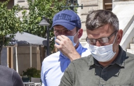 Manchester United football team captain Harry Maguire (L) leaves a courthouse on the Greek island of Syros, the administrative hub of the Cycladic island group that includes Mykonos on August 22, 2020. Maguire was released from Greek police custody on August 22, 2020, TV footage showed, pending a hearing on assault charges on the neighbouring island of Mykonos. The £80 million (88 million euros) defender was arrested late on August 20, after what Greek police described as an "altercation" between two groups of British tourists on Mykonos. PHOTO: EUROKINISSI / AFP