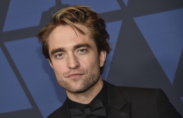 (FILES) In this file photo taken on October 27, 2019 British actor Robert Pattinson arrives to attend the 11th Annual Governors Awards gala hosted by the Academy of Motion Picture Arts and Sciences at the Dolby Theater in Hollywood. - Robert Pattinson showcased "The Batman" footage and Dwayne "The Rock" Johnson hyped up his new anti-hero movie "Black Adam" as Hollywood A-listers and their comic-book alter-egos hosted a sprawling DC Comics online gathering August 22, 2020. (Photo by Chris Delmas / AFP)
