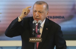 Turkish President and Leader of Turkey's ruling Justice and Development (AK) Party Recep Tayyip Erdogan gestures as he delivers a speech during an event held for the AK Party's 19th foundation anniversary in Ankara, on August 13, 2020. (Photo by Adem ALTAN / AFP)