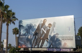 This photo taken on August 19, 2020 shows a billboard for Christopher Nolan's film "Tenet" on the Sunset Strip, August 19, 2020, in West Hollywood, California. (Photo by VALERIE MACON / AFP)