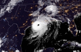 This RAMMB/NOAA satellite image shows Hurricane Laura reaching the coasts of Louisana and Texas on August 26, 2020 at 19H20 Pacific time, (02:20UTC August 27, 2020). - Hurricane Laura was barreling towards the coast of the southern US states of Louisiana and Texas on Wednesday as a monster Category 4 storm, prompting warnings of "unsurvivable" storm surge and evacuation orders for hundreds of thousands of Gulf Coast residents.Islands (L). (Photo by - / RAMMB/NOAA/NESDIS / AFP) / 