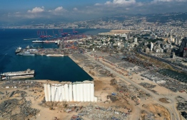 An aerial view taken on August 26, 2020, shows the port of Beirut with the grain silo in the foreground and surrounding neighbourhoods, devastated in the August 4 massive explosion that caused severe damage across swathes of the Lebanese capital, killed at least 181 people, injured more than 6,500 and left scores of people homeless. PHOTO: AFP