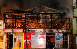 The blaze in Malé City on Friday night completely destroyed the two-storey Café Tiolo building. PHOTO: MIHAARU