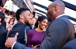 Chadwick Boseman greets Kobe Bryant at the Oscars at the Dolby Theatre in Los Angeles, on March 4, 2018. PHOTO: CHARLES SYKES / INVISION, AP