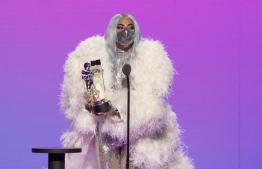 This handout image released courtesy of MTV shows US singer-songwriter Lady Gaga accepting the award for Artist of the Year during the 2020 MTV Video Music Awards, being held virtually amid the coronavirus pandemic, broadcast on August 30, 2020 in New York. (Photo by - / MTV / AFP) / 