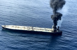 This handout photograph taken on September 3, 2020, and released by Sri Lanka's Air Force, shows black smoke coming out from the Panamanian-registered crude oil tanker, MT New Diamond, some 60 kilometres (38 miles) off Sri Lanka's eastern coast where it reported a fire inside the engine room. - At least 20 crew were rescued from a burning Panamanian-registered oil tanker off the coast of Sri Lanka on September 3, the navy said. Three naval craft were sent to aid the MT New Diamond which reported an engine room fire, Sri Lanka navy spokesman Captain Indika de Silva said. (Photo by - / Sri Lankan Air Force / AFP) / 