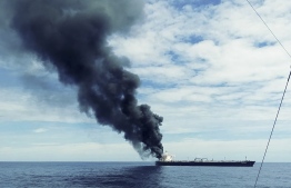 This handout photograph taken on September 3, 2020, and released by Sri Lanka's Air Force, shows black smoke coming out from the Panamanian-registered crude oil tanker New Diamond, some 60 km off Sri Lanka's eastern coast.  (Photo by - / Sri Lankan Air Force / AFP) /