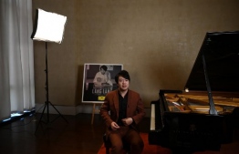 This photo taken on September 3, 2020 shows Chinese pianist Lang Lang speaking during an interview in Beijing, ahead of the release of his new album featuring studio recordings and live performances of Johann Sebastian Bach's Goldberg Variations. (Photo by GREG BAKER / AFP)