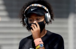 (FILES) In this file photo Naomi Osaka of Japan makes her way to the court for her semifinal match against Elise Mertens of Belgium during the Western & Southern Open at the USTA Billie Jean King National Tennis Center on August 28, 2020 in the Queens borough of New York City. "For me, I just want to spread awareness," Osaka said after her 6-2, 5-7, 6-2 win over Japanese compatriot Misaki Doi. - Naomi Osaka arrived on court for her opening US Open game on August 31, 2020 wearing a face mask bearing the name of Breonna Taylor, the African-American nurse shot dead by police who raided her apartment in Kentucky in March. By the time the US Open fortnight is over, Osaka says she hopes to have honored the memory of six other victims of racial injustice. (Photo by MATTHEW STOCKMAN / GETTY IMAGES NORTH AMERICA / AFP)