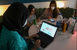 In this picture taken on August 31, 2020, women discuss as they check out the social online group 'The Soul Sisters Pakistan' on their Facebook page, in Lahore.† - "Women in Pakistan are really, really strong. We have a voice. We just donít have enough spaces to use that voice," says Kanwal Ahmed, an agony aunt to some 260,000, determined to change the situation. Her female-only online hub sees traditionally taboo topics such as sex, divorce, and domestic violence discussed freely in a conservative country where there are few avenues for women to discuss personal problems. (Photo by Arif ALI / AFP) / 