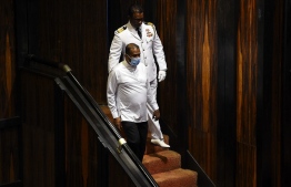 Sri Lanka's convicted murderer Premalal Jayasekara (L) arrives for a sworn in as a member of parliament from the ruling party in Colombo on September 8, 2020. - Jayasekara becomes the first convict facing a death sentence to become a legislator in Sri Lanka. (Photo by ISHARA S. KODIKARA / AFP)