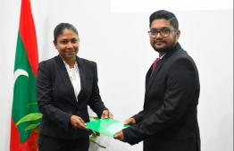 Head of JSC Hisaan Hussain (L) presents Letter of Appointment to newly sworn in judge, Adam Mohamed: Judge Adam has been appointed as the acting chief judge at the Criminal Court. FILE PHOTO/MIHAARU