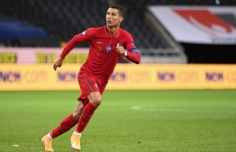Portugal's forward Cristiano Ronaldo celebrates scoring his 100th goal for Portugal, during the UEFA Nations League football match between Sweden and Portugal on September 8, 2020 in Solna, Sweden. (Photo by Jonathan NACKSTRAND / AFP)