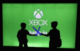 (FILES) In this file photo young XBox game enthusiasts play with toy light sabers during the E3 Video Game Convention at the Microsoft Theater on June 11, 2019 in Los Angeles, California. - Microsoft said September 9, 2020 its next-generation Xbox game console will launch on November 10,2020 with an estimated starting price of $499.The new XBox Series X, Microsoft's flagship console which competes notably against Sony's PlayStation devices, will be available for pre-orders from September 22. (Photo by Christian Petersen / GETTY IMAGES NORTH AMERICA / AFP)