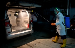 This picture taken on September 9, 2020 shows a hospital worker disinfecting the interior of an ambulance before transporting a coffin, bearing the body of a patient who succumbed to the COVID-19 coronavirus, at the Bogor general hospital in Bogor, West Java. Indonesia on September 9 reported at least 203,342 confirmed cases and over 8,336 deaths due to the coronavirus. With some of the world’s lowest testing rates, the true scale is widely believed to be much greater. PHOTO: ADEK BERRY / AFP