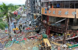Firefighters work at the scene of an explosion in Zhuhai, in China's southern Guangdong province on September 11, 2020. - At least three people were injured on September 11 when a gas pipe exploded in a store in the southern city of Zhuhai, local officials said. (Photo by - / AFP) / 