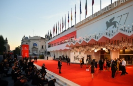 A general view shows press photographers waiting for guests to arrive at the festival's palace for the screening of the film "Nomadland" presented in competition on the tenth day of the 77th Venice Film Festival, on September 11, 2020 at Venice Lido, during the COVID-19 infection, caused by the novel coronavirus. (Photo by Alberto PIZZOLI / AFP)