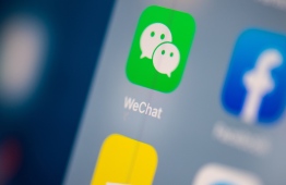 FILES) In this file photo illustration taken on July 24, 2019, shows the logo of the Chinese instant messaging application WeChat on the screen of a tablet, in Paris. US officials on September 18, 2020, ordered a ban on downloads of the popular Chinese-owned mobile applications WeChat and TikTok from September 20, saying they threaten national security. The move comes amid rising US-China tensions over technology and a Trump administration effort to engineer a sale of the video app TikTok to American investors. Martin BUREAU / AFP