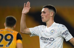 Manchester City's English midfielder Phil Foden celebrates scoring his team's second goal during the English Premier League football match between Wolverhampton Wanderers and Manchester City at the Molineux stadium in Wolverhampton, central England on September 21, 2020. (Photo by Stu Forster / POOL / AFP) / RESTRICTED TO EDITORIAL USE. No use with unauthorized audio, video, data, fixture lists, club/league logos or 'live' services. Online in-match use limited to 120 images. An additional 40 images may be used in extra time. No video emulation. Social media in-match use limited to 120 images. An additional 40 images may be used in extra time. No use in betting publications, games or single club/league/player publications. / 