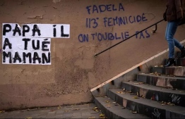 "Dad killed my mom," part of a Paris graffiti campaign to highlight domestic violence PHOTO: LIONEL BONAVENTURE / AFP