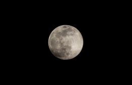 (FILES) In this file photo taken on April 07, 2020, the "supermoon", one of the biggest full moons of the year, shines in the sky in Ronda, Spain. - A Canadian astronaut will take part in a lunar mission for the first time in 2023, as part of the NASA-led Artemis project. (Photo by JORGE GUERRERO / AFP)