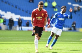 Manchester United's Portuguese midfielder Bruno Fernandes celebrates after he takes a penalty and scores his team's third goal during the English Premier League football match between Brighton and Hove Albion and Manchester United at the American Express Community Stadium in Brighton, southern England on September 26, 2020. (Photo by Glyn KIRK / POOL / AFP)