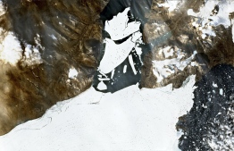 (FILES) In this file handout satellite image captured on August 27, 2020 by the Copernicus Sentinel-2 mission and released by European Space Agency (ESA) shows ice breaking off the Nioghalvfjerdsfjorden glacier in Northeast Greenland. - Arctic summer sea ice melted in 2020 to the second smallest area since records began 42 years ago, US scientists announced on September 21, 2020. The year's minimum was reached on September 15, at 3.74 million square kilometers (1.44 million square miles), according to scientists at the National Snow and Ice Data Center (NSIDC) at the University of Colorado Boulder. (Photo by Handout / EUROPEAN SPACE AGENCY / AFP) / 